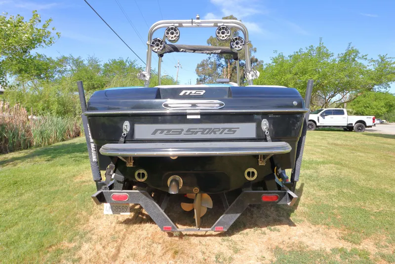 Slide: The Image of Rear view of a 2012 MB B-52 23 Widebody boat on grass. - 4