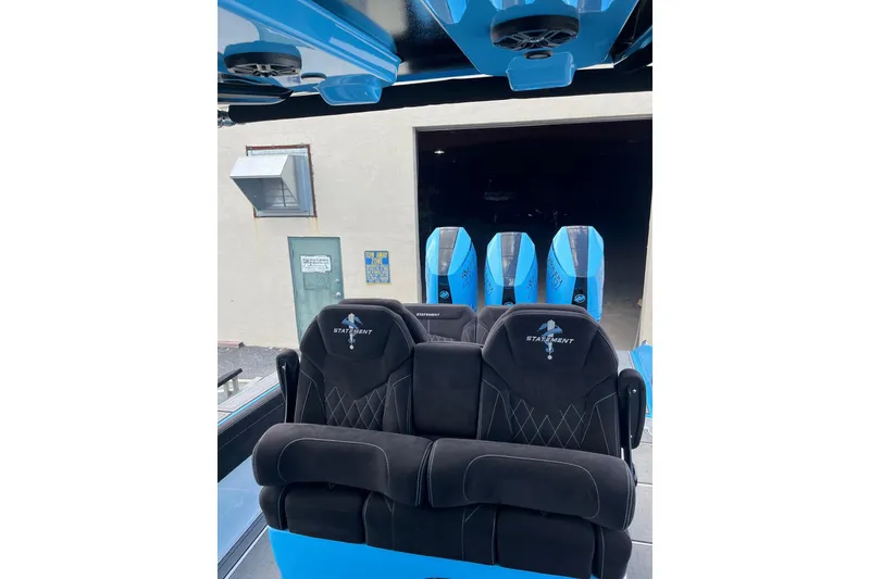 Slide: The Image of Luxury seating on 2025 Statement 350 Open boat with blue accents and powerful engines. - 15