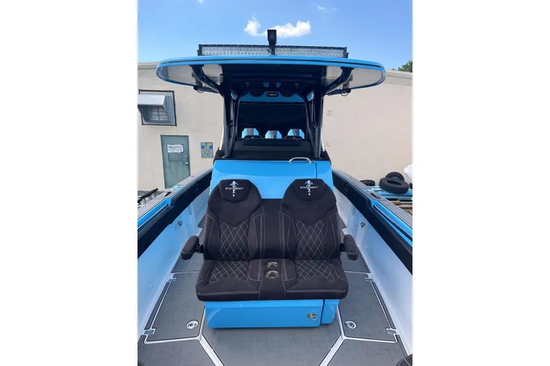 Slide: The Image of 2025 Statement 350 Open boat interior with dual black seats and blue accents. - 18