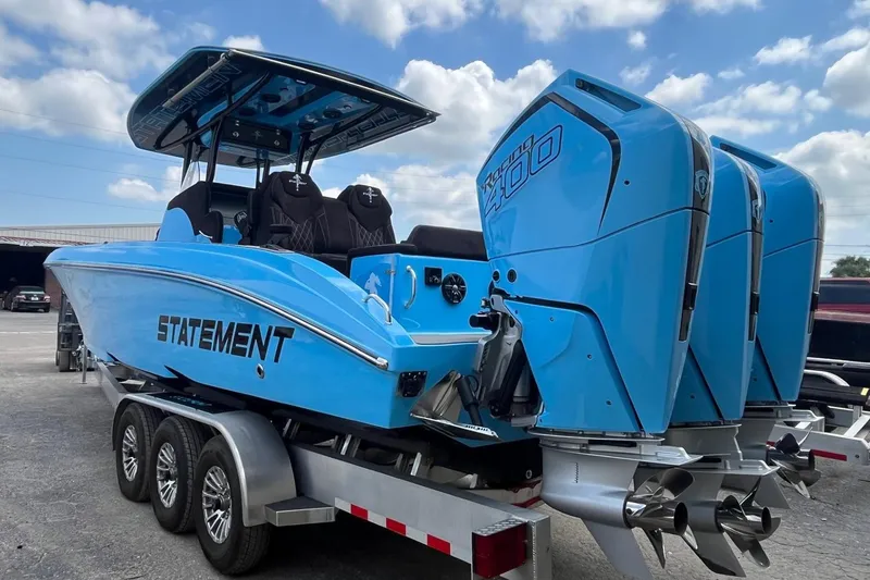 Slide: The Image of Blue 2025 Statement 350 Open boat with triple outboard engines on a trailer. - 5