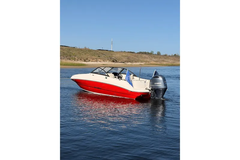 The Image of 2023 Stingray 201 DC boat with Yamaha engine on calm water. - 0
