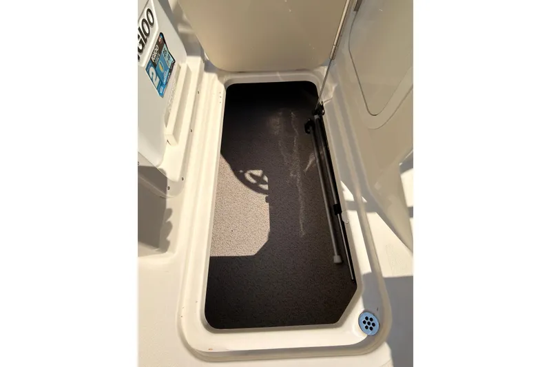 Slide: The Image of 2023 Stingray 201 DC boat interior with cushioned seating and cup holders. - 12