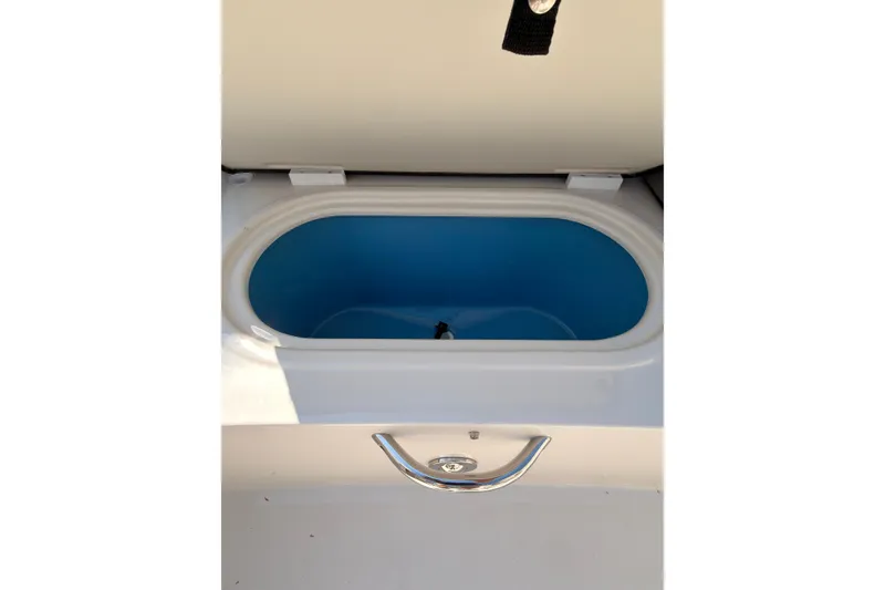 Slide: The Image of Interior of 2023 Stingray 201 DC boat, featuring seating and storage compartments. - 13