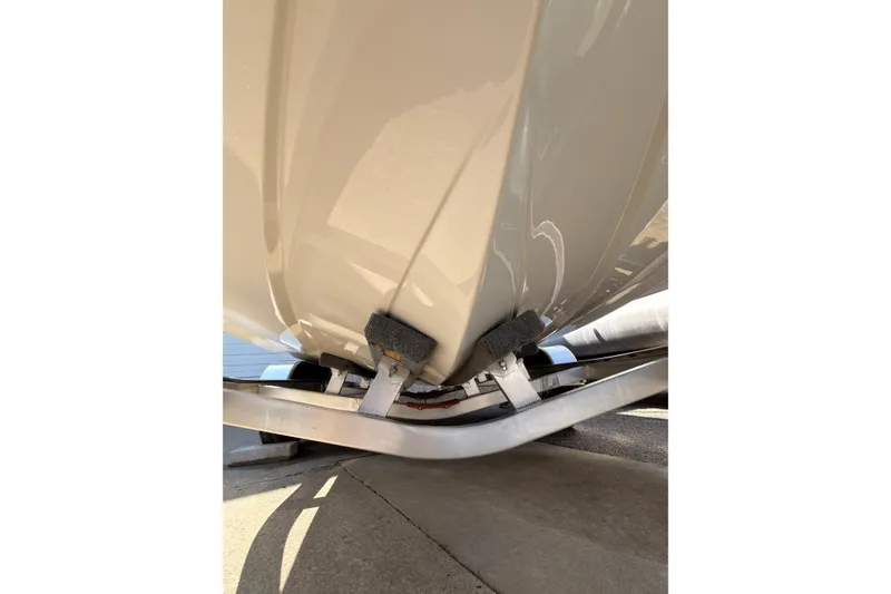 Slide: The Image of 2023 Stingray 201 DC boat storage compartment with open hatch and visible drain. - 18