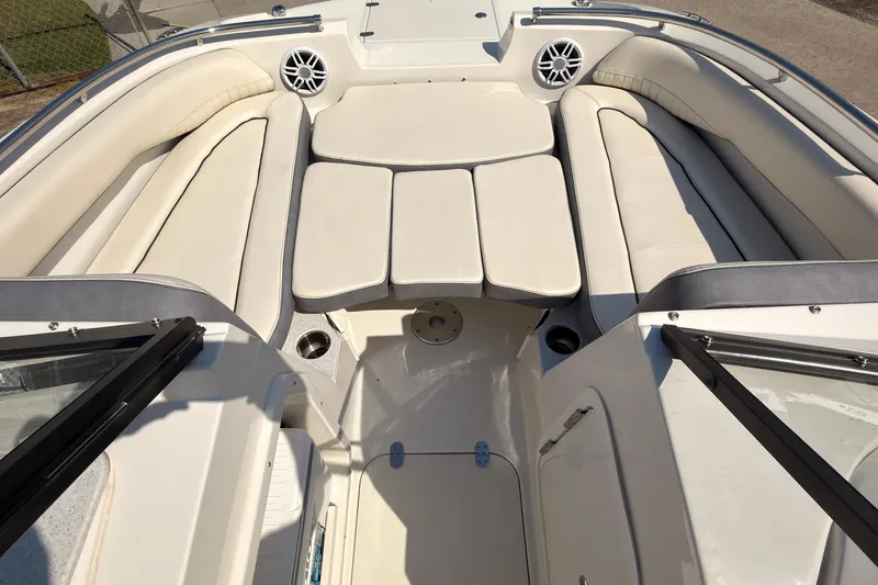 Slide: The Image of 2023 Stingray 201 DC boat on water, displaying American and blue flags. - 5