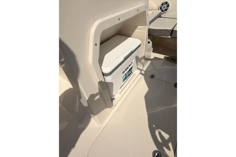 Slide: The Image of 2023 Stingray 201 DC boat with cover on trailer, red and white exterior. - 9