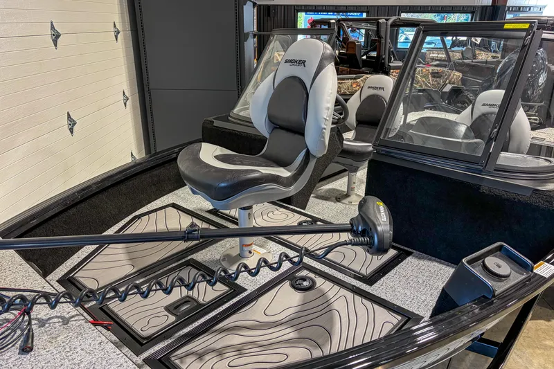 Slide: The Image of 2026 Smoker Craft Excursion 176 DC boat interior with seating and control panel. - 10