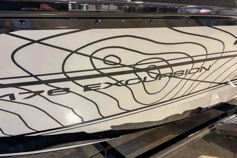 Slide: The Image of 2026 Smoker Craft Excursion 176 DC boat with sleek contour design graphics. - 2
