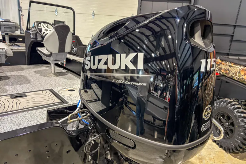 Slide: The Image of 2026 Smoker Craft Excursion 176 DC with Suzuki 115 outboard motor in showroom. - 4