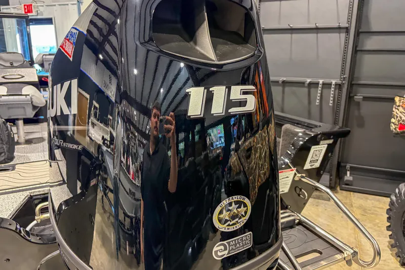 Slide: The Image of 2026 Smoker Craft Excursion 176 DC with Suzuki 115 outboard motor in showroom. - 5