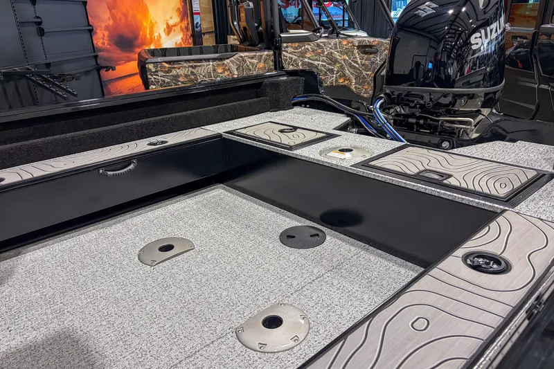 Slide: The Image of 2026 Smoker Craft Excursion 176 DC boat interior with Suzuki engine, featuring sleek design and storage compartments. - 6