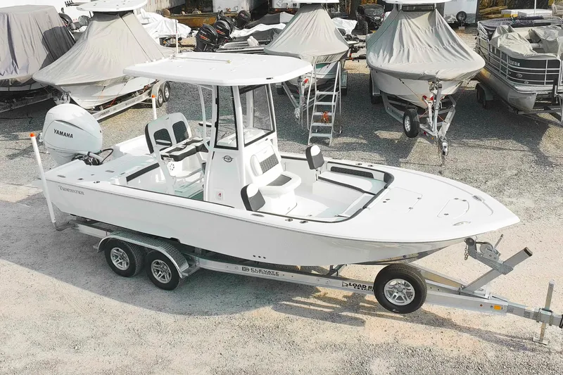 The Image of 2026 Tidewater 2300 Carolina Bay boat on trailer in a marina setting. - 1