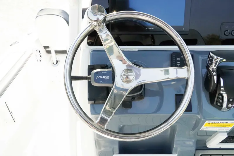 Slide: The Image of Steering wheel and controls of 2026 Tidewater 2300 Carolina Bay boat. - 11