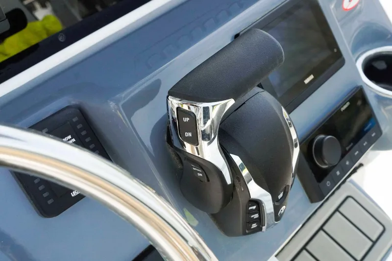 Slide: The Image of Control panel of 2026 Tidewater 2300 Carolina Bay boat with throttle and steering wheel. - 12