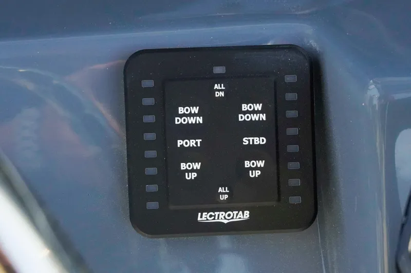 Slide: The Image of Control panel of 2026 Tidewater 2300 Carolina Bay boat with Lectrotab trim tab switches. - 13