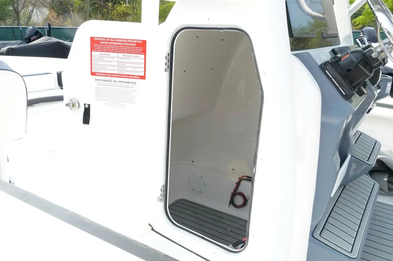 Slide: The Image of Open storage compartment on 2026 Tidewater 2300 Carolina Bay boat deck. - 18