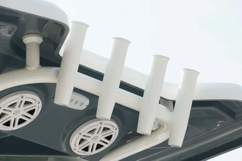 Slide: The Image of 2026 Tidewater 2300 Carolina Bay boat speakers and rod holders, close-up view. - 23