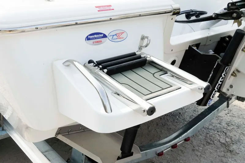 Slide: The Image of 2026 Tidewater 2300 Carolina Bay boat with foldable swim ladder and Yamaha PowerMatched system. - 29