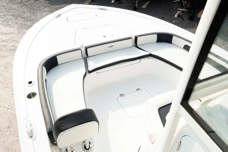 Slide: The Image of 2026 Tidewater 2300 Carolina Bay boat interior with cushioned seating and storage compartments. - 31