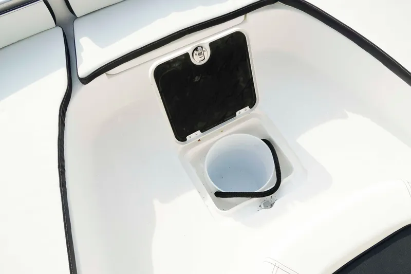 Slide: The Image of 2026 Tidewater 2300 Carolina Bay boat interior with storage compartment and bucket. - 35