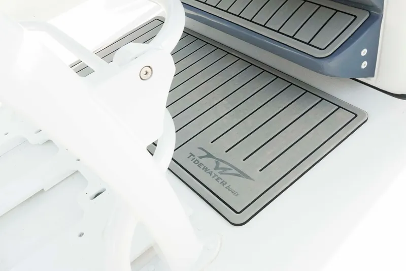 Slide: The Image of 2026 Tidewater 2300 Carolina Bay boat deck with branded mat and seating. - 8