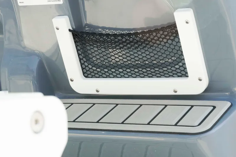 Slide: The Image of 2026 Tidewater 2300 Carolina Bay boat with netted storage compartment detail. - 9
