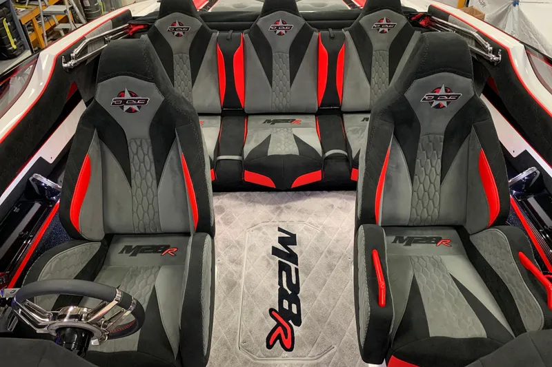Slide: The Image of 2021 Daves Custom Boats M-28R interior with black and red seating design. - 11