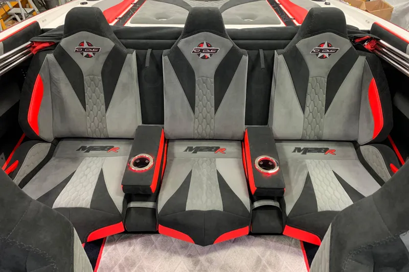 Slide: The Image of 2021 Daves Custom Boats M-28R interior with gray and red seating, featuring cup holders. - 12