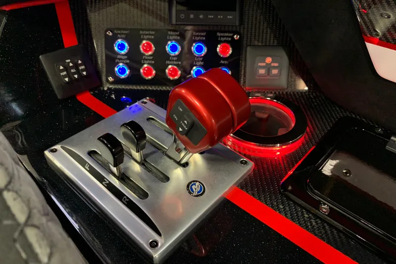 Slide: The Image of Control panel of 2021 Daves Custom Boats M-28R with illuminated switches and throttle levers. - 15