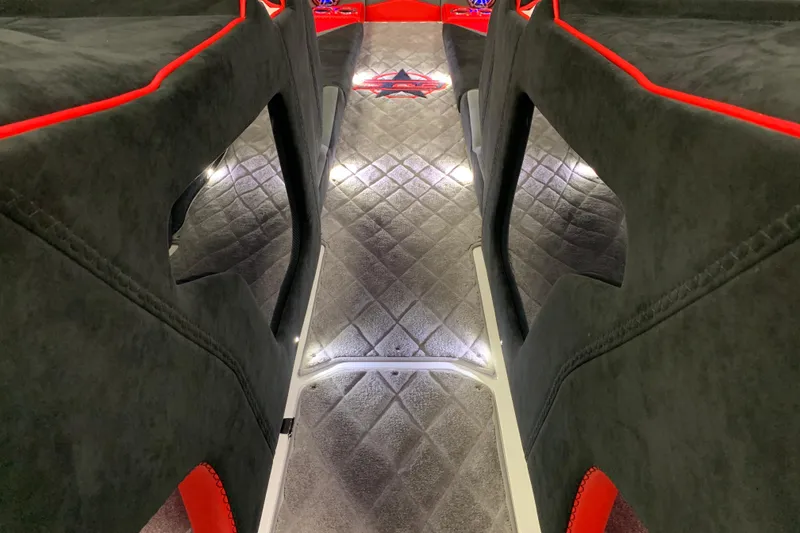 Slide: The Image of Interior of 2021 Daves Custom Boats M-28R with plush seating and ambient lighting. - 16
