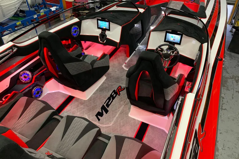 Slide: The Image of 2021 Daves Custom Boats M-28R interior with red LED lighting and modern dashboard. - 17