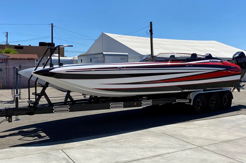 Slide: The Image of 2021 Daves Custom Boats M-28R on trailer, sleek design, vibrant red and white colors. - 18