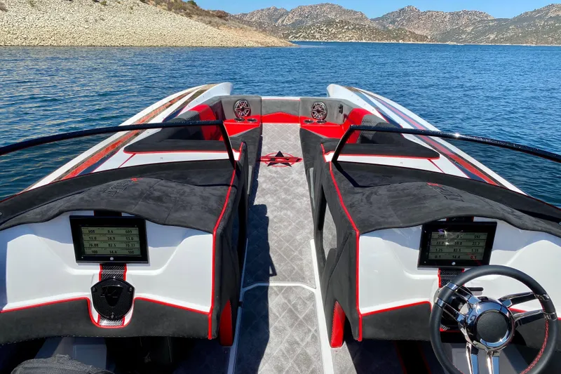 Slide: The Image of 2021 Daves Custom Boats M-28R interior with dual consoles on a scenic lake. - 4