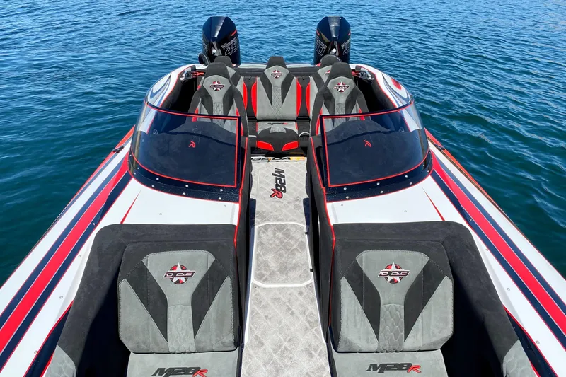 Slide: The Image of 2021 Daves Custom Boats M-28R on water, featuring sleek design and dual seating. - 5