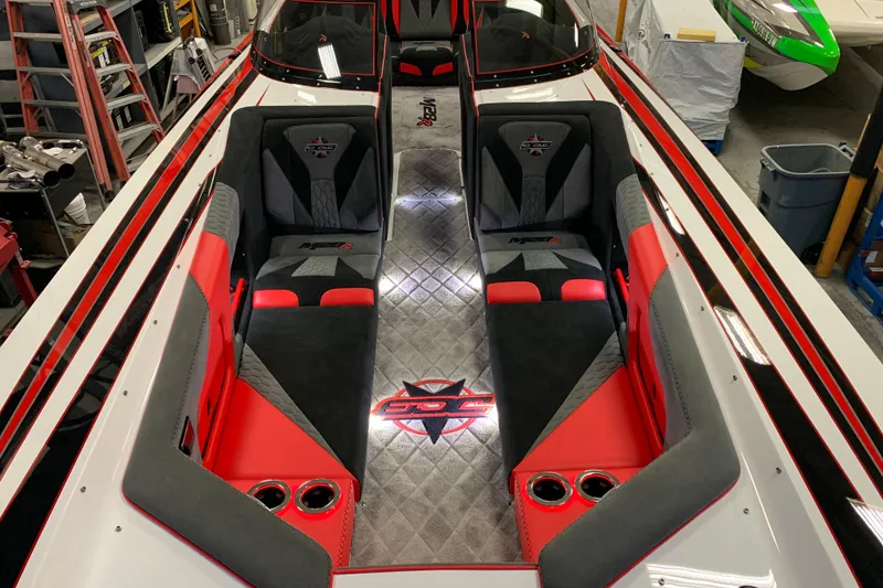 Slide: The Image of 2021 Daves Custom Boats M-28R interior with red and black seating, sleek design. - 7