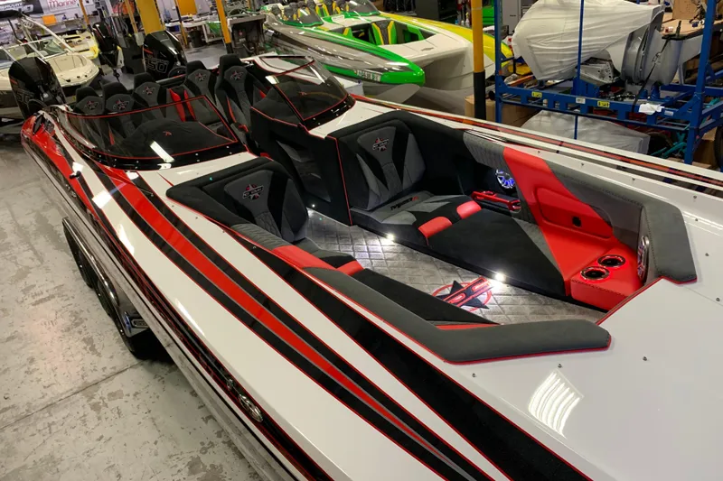 Slide: The Image of 2021 Daves Custom Boats M-28R with sleek red and black interior design. - 8