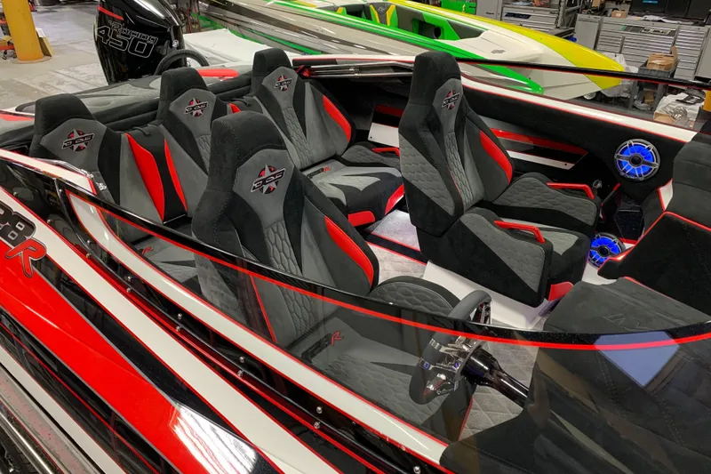 Slide: The Image of 2021 Daves Custom Boats M-28R interior with sleek black and red seating design. - 9