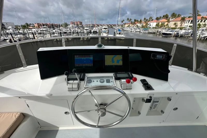 Slide: The Image of Pilothouse of 2005 Jefferson Pilothouse 63 yacht with navigation equipment and marina view. - 11