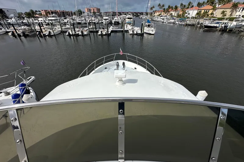 Slide: The Image of Bow view of 2005 Jefferson Pilothouse 63 yacht in a marina setting. - 12