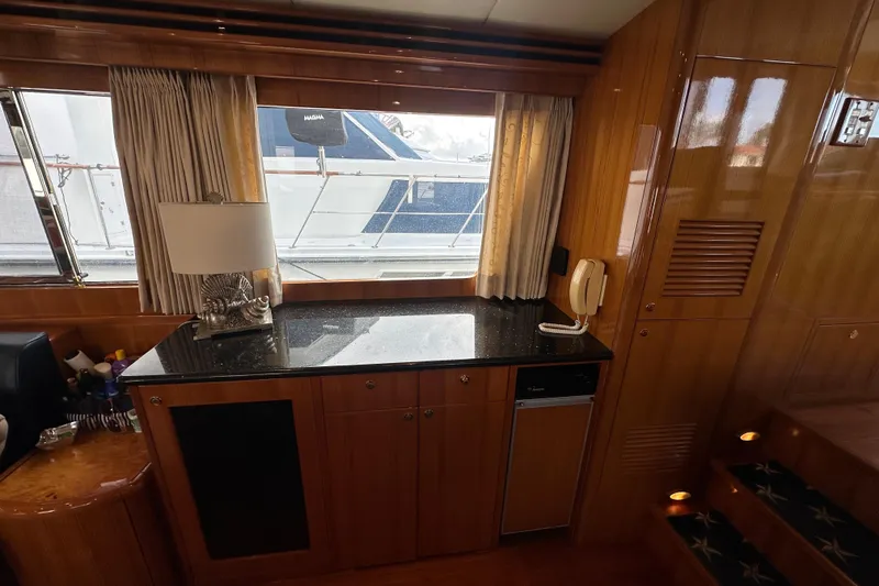 Slide: The Image of Luxurious interior of 2005 Jefferson Pilothouse 63 yacht with wooden cabinetry and granite countertop. - 18