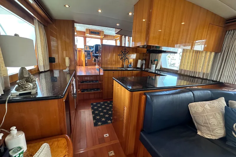 Slide: The Image of Luxurious interior of a 2005 Jefferson Pilothouse 63 yacht with elegant wood finishes. - 19