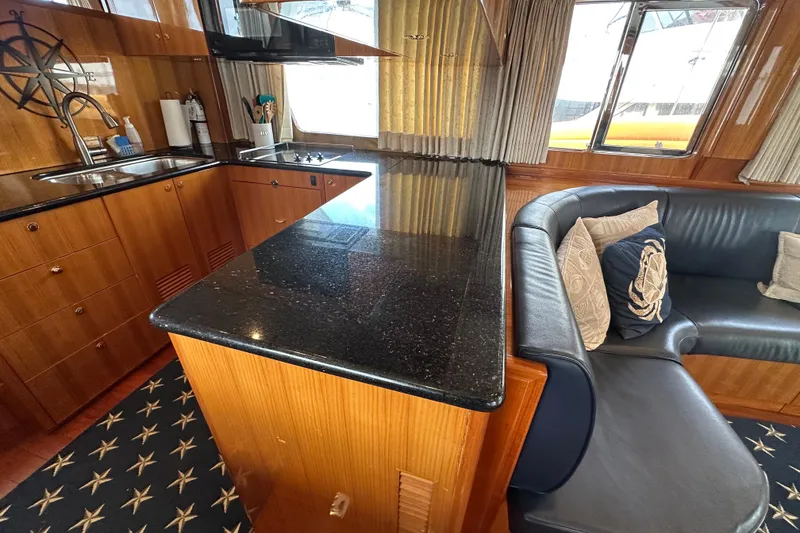 Slide: The Image of Luxurious interior of a 2005 Jefferson Pilothouse 63 yacht with kitchen and seating area. - 24