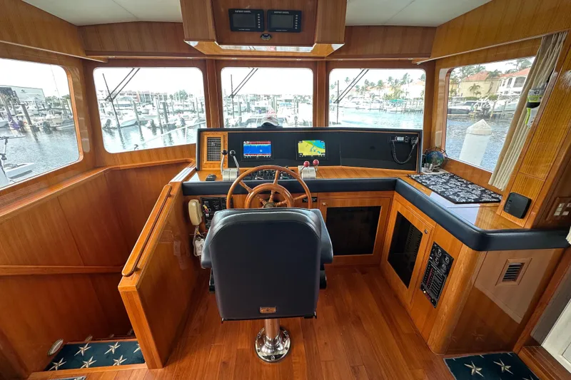 Slide: The Image of Pilothouse interior of 2005 Jefferson Pilothouse 63 yacht with wooden finish and navigation equipment. - 25