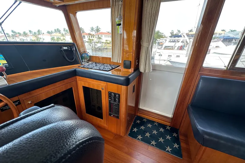 Slide: The Image of Interior of 2005 Jefferson Pilothouse 63 yacht with wood paneling and seating. - 27