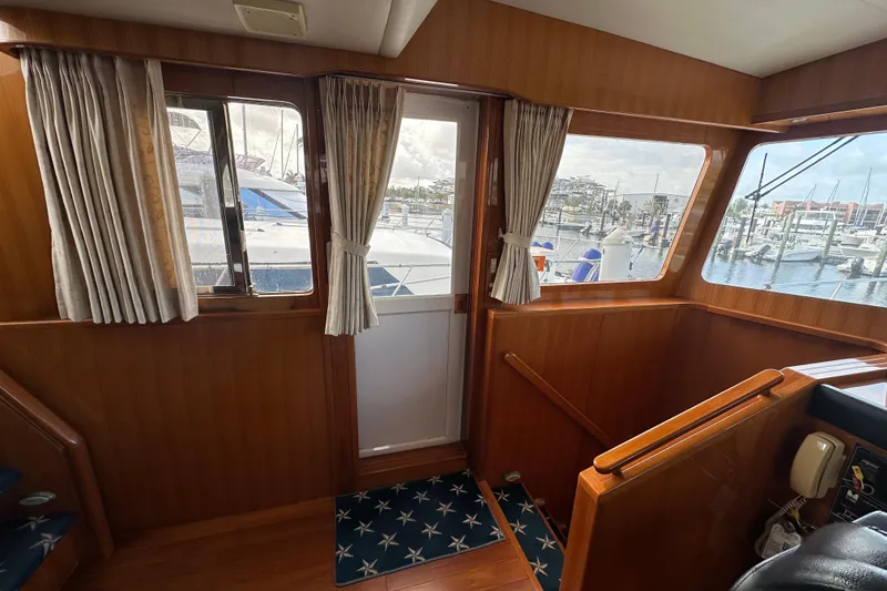 Slide: The Image of Interior view of 2005 Jefferson Pilothouse 63 yacht with marina in background. - 29