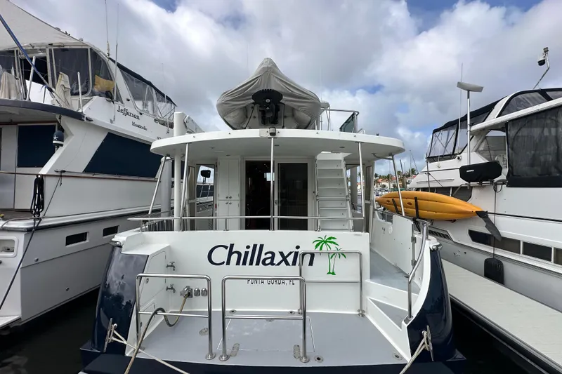 Slide: The Image of 2005 Jefferson Pilothouse 63 yacht "Chillaxin" docked with kayaks on the side. - 3