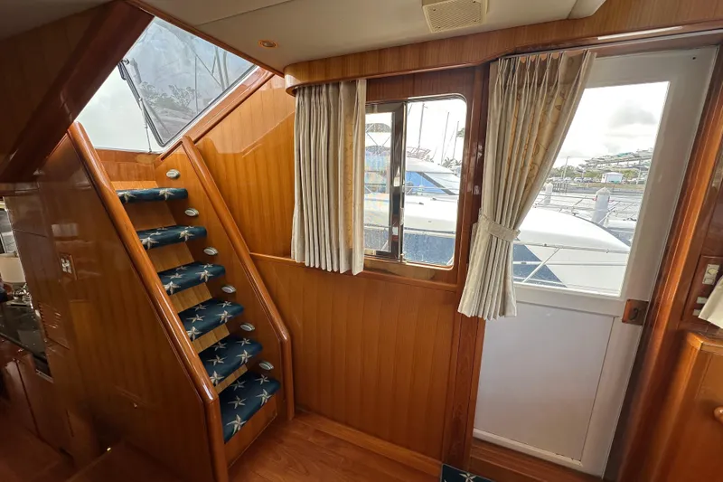 Slide: The Image of Interior of 2005 Jefferson Pilothouse 63 yacht with wooden stairs and window view. - 30