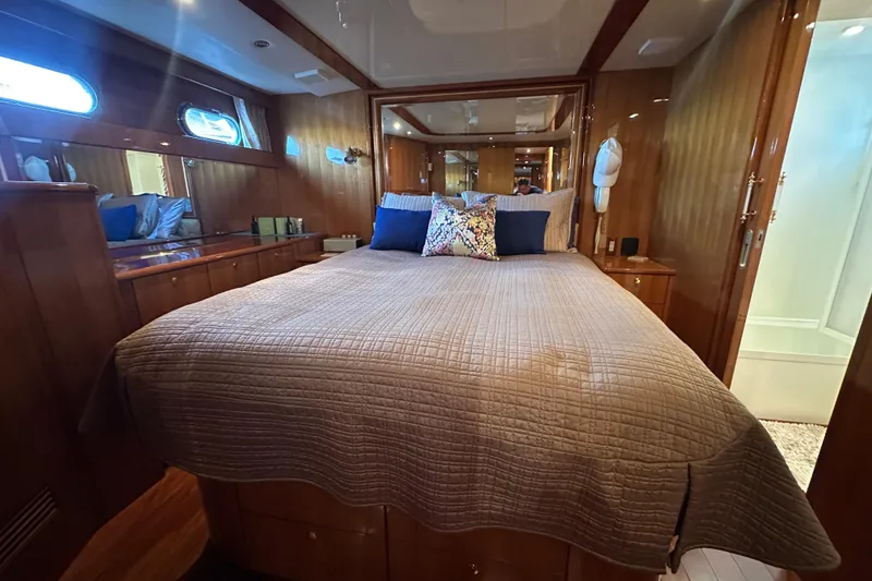 Slide: The Image of Luxurious bedroom interior of 2005 Jefferson Pilothouse 63 yacht with elegant wood finishes. - 33