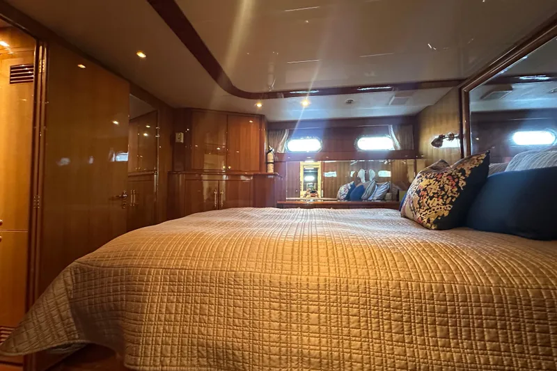 Slide: The Image of Luxurious bedroom interior of 2005 Jefferson Pilothouse 63 yacht with elegant wood finishes. - 34