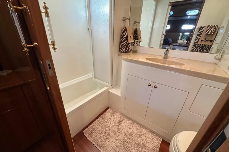 Slide: The Image of Luxurious bathroom in 2005 Jefferson Pilothouse 63 yacht with shower and vanity. - 35